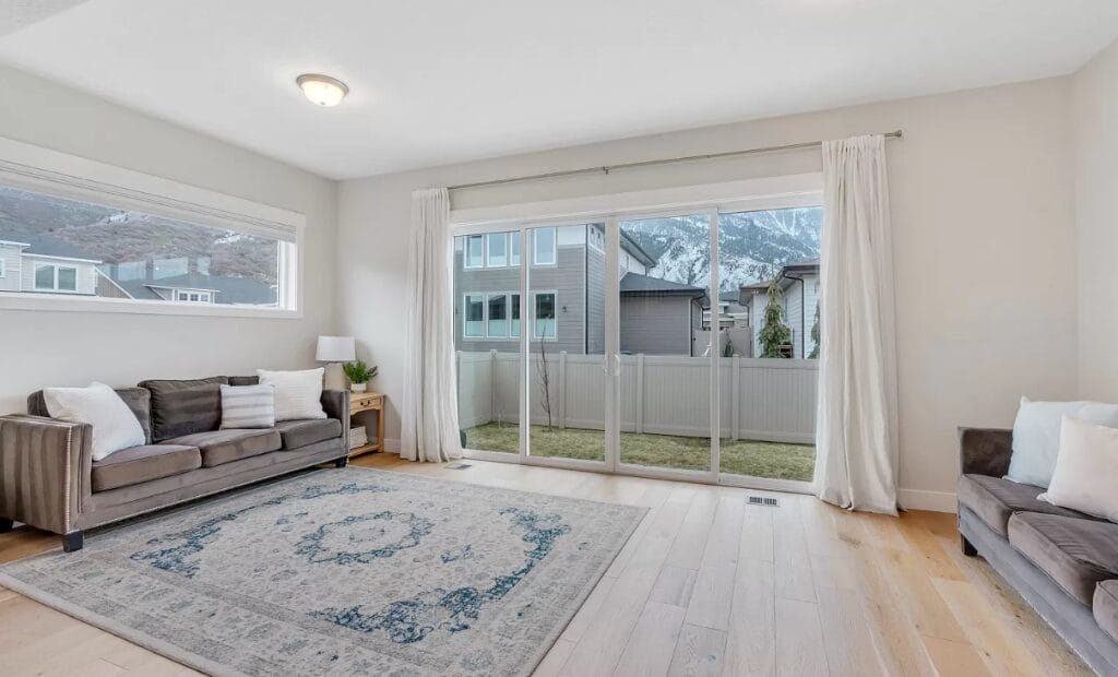 garage conversion living room gray sofas blue rug denver co