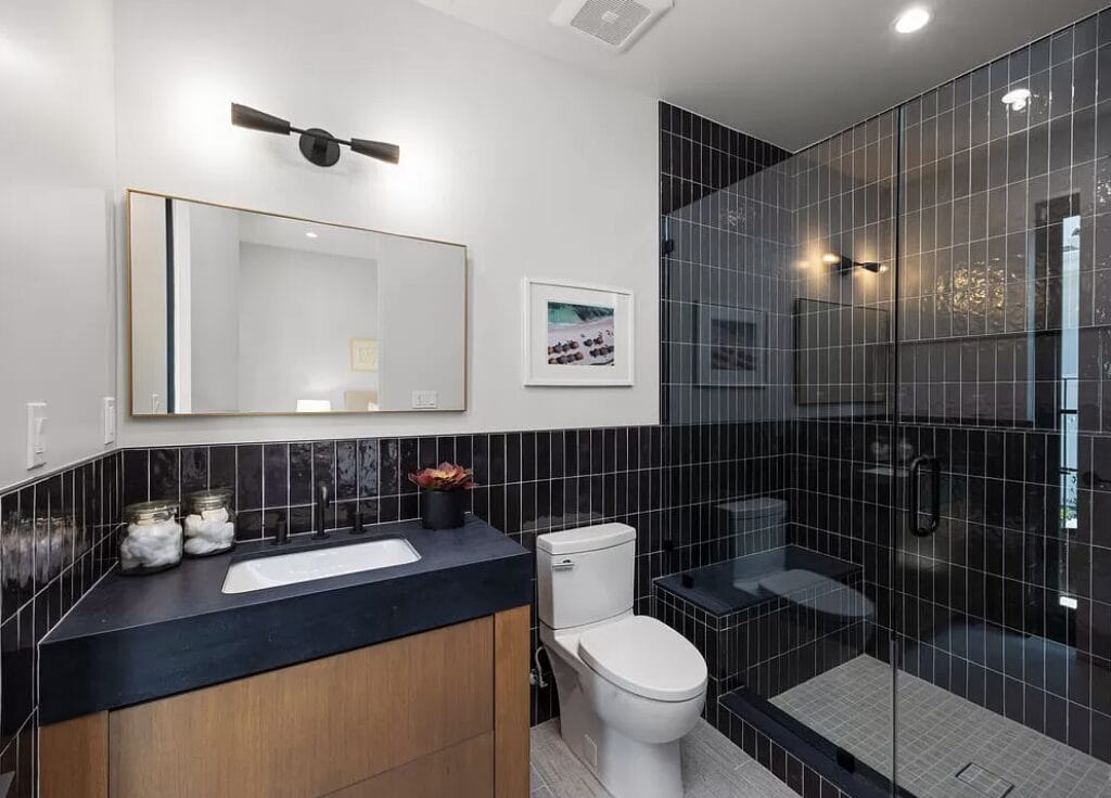 sleek bathroom black countertop wooden cabinetry denver co