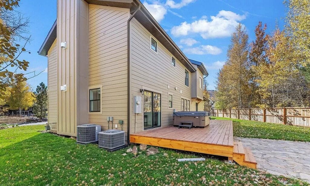 wooden deck addition two story house beige siding denver co